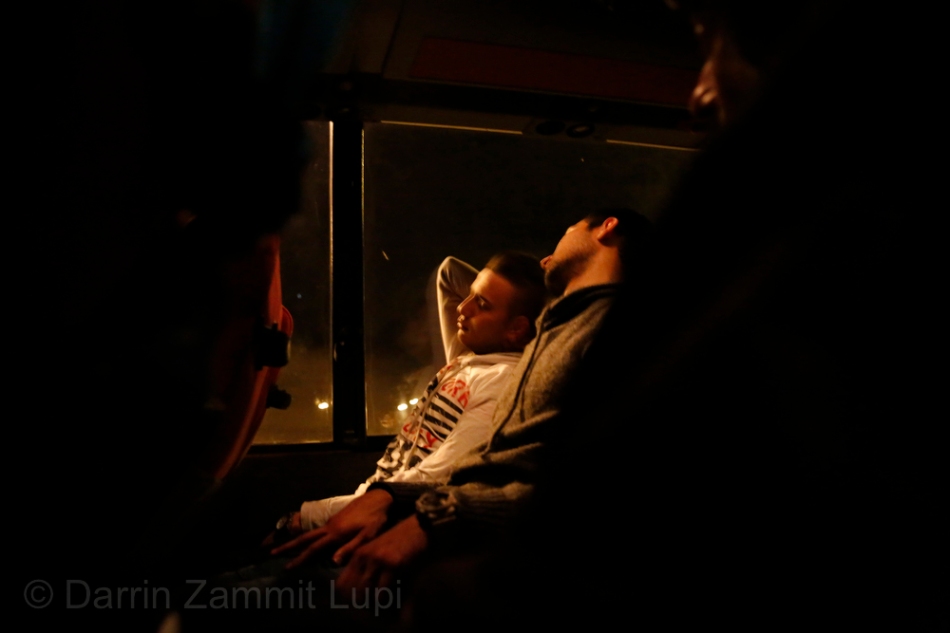 Migrants sleep on a bus transporting them overnight from Athens, Greece, to the village of Idomeni on the Greek-Macedonian border