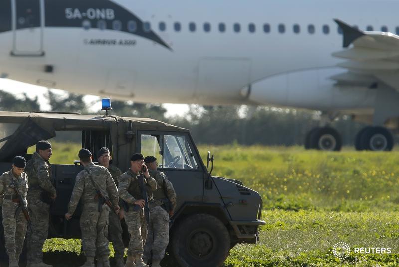 Maltese troops survey a hijacked Libyan Afriqiyah Airways Airbus A320 on the runway at Malta Airport